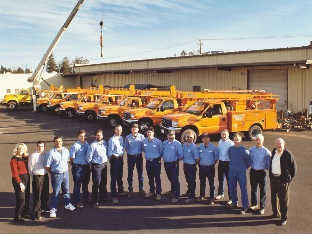 group of employees from PumpMan-NorCal posing in front of service trucks